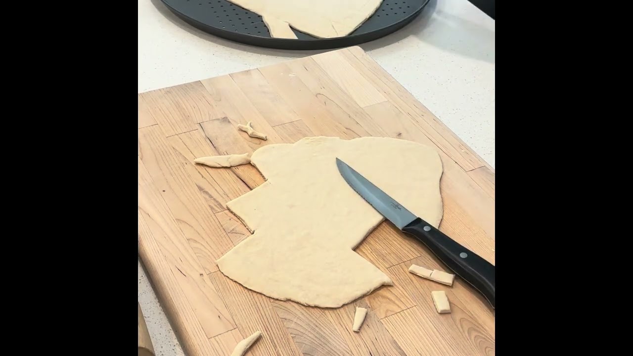 My daughter making a heart pizza for college. 