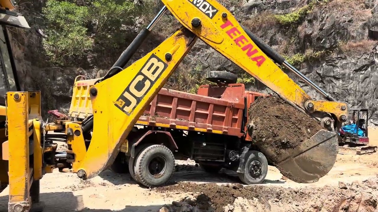 Jcb 3dx digging soil and loading into swaraj mazda truck