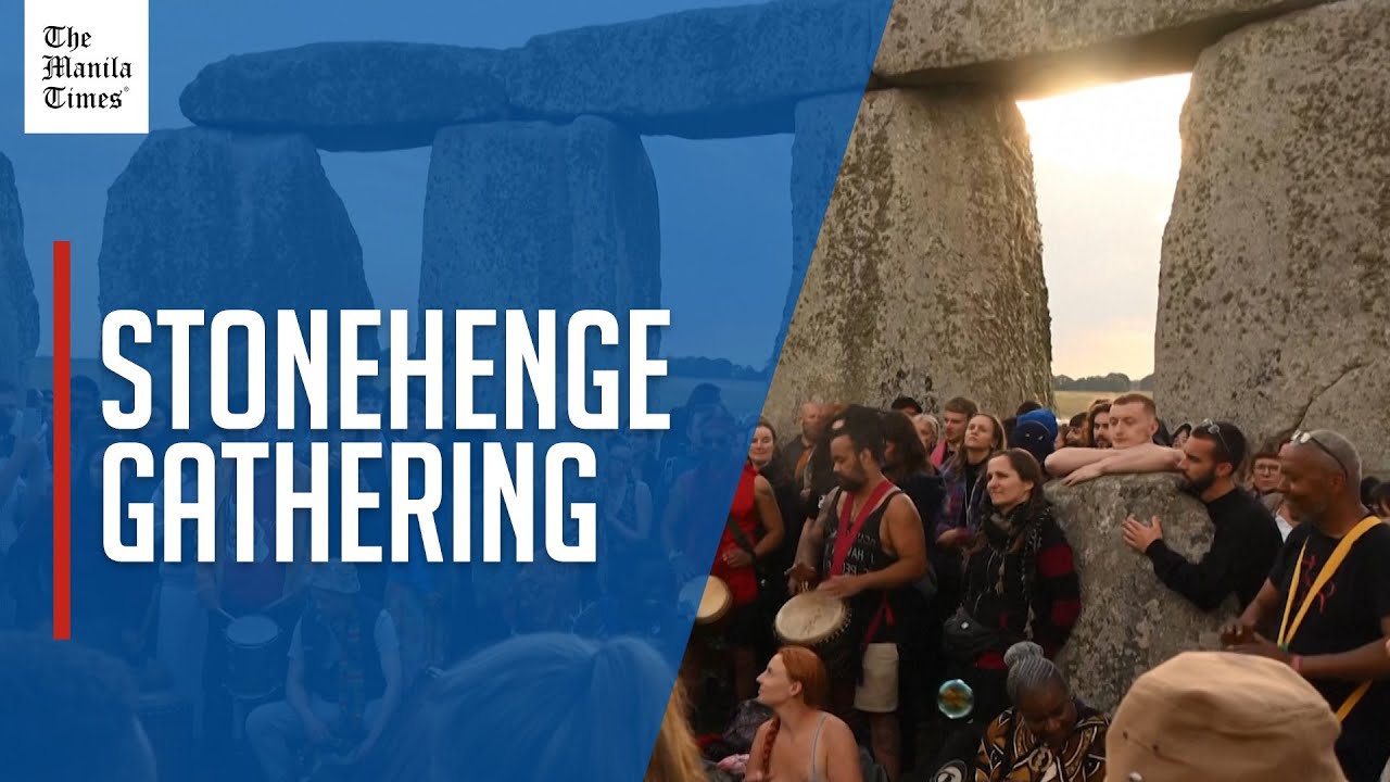 Crowds celebrate the sunrise at Stonehenge for summer solstice