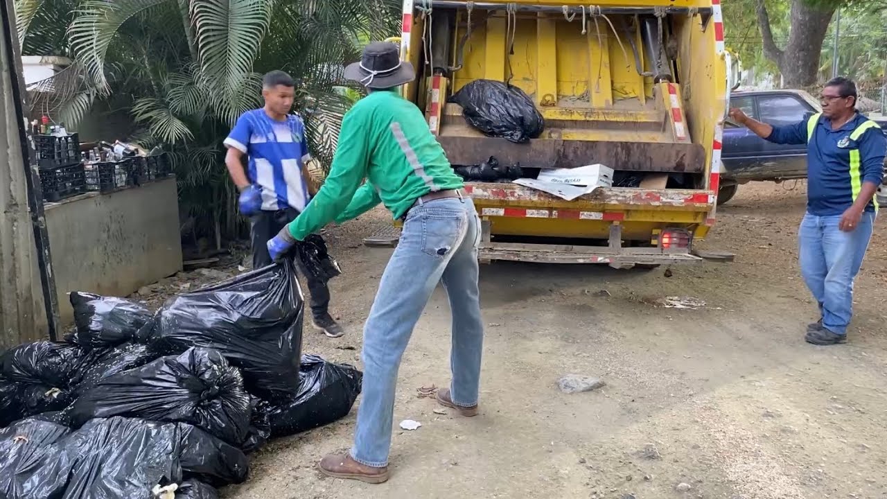 Costa Rica garbage truck on heavy manual trash