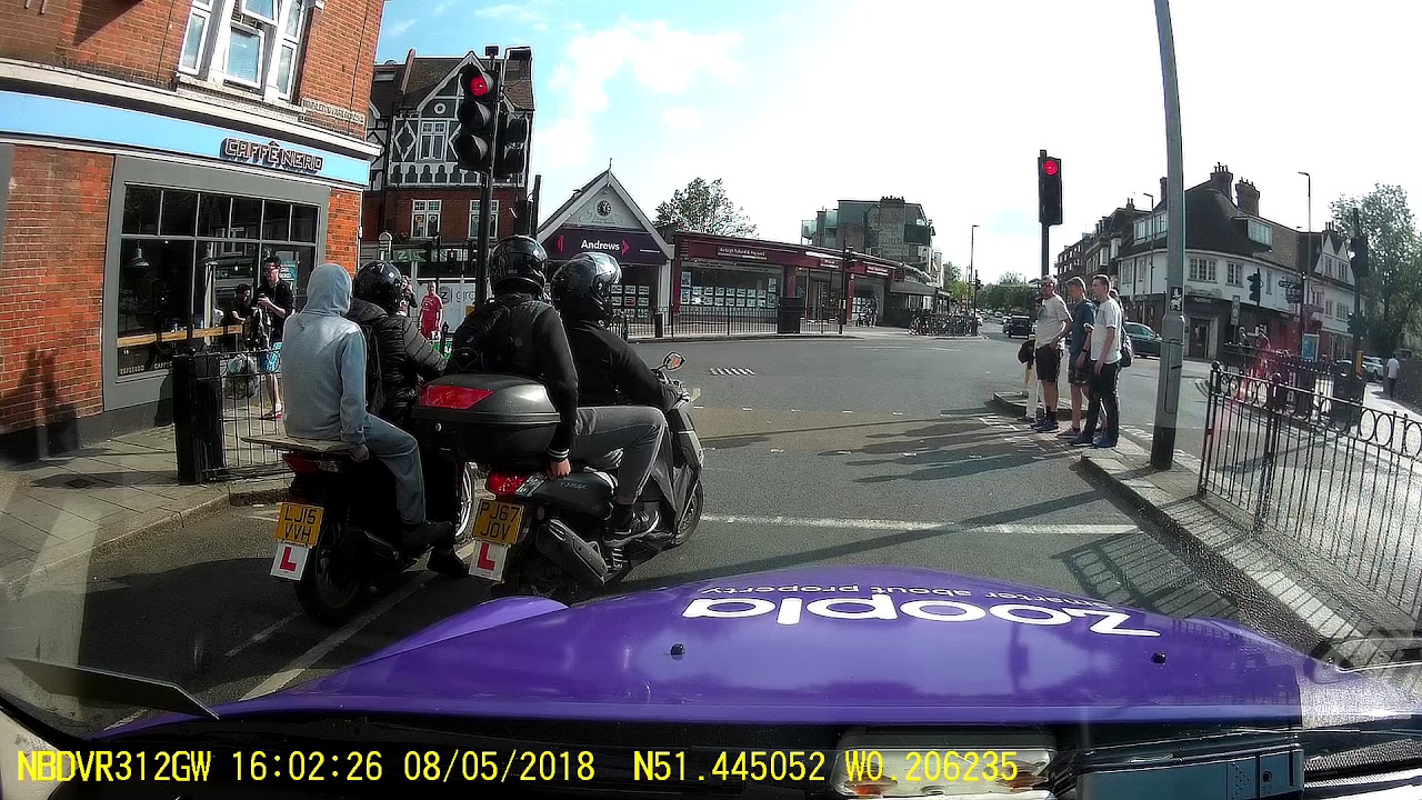 Moped riders, on L plates carrying passengers and no helmets