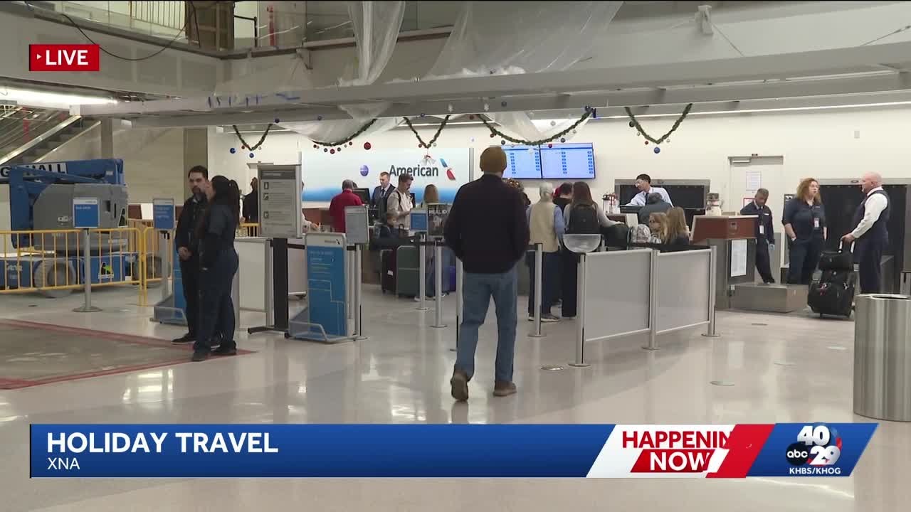 Passengers make their way through XNA to their holiday destinations