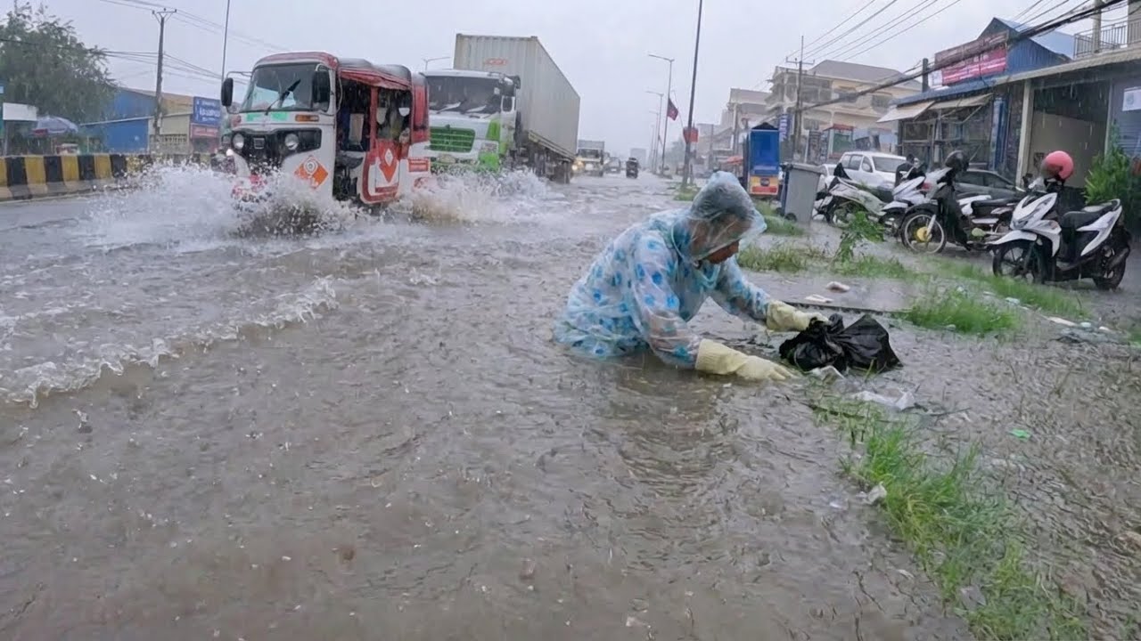 Opening a Blocked Drain During Heavy Street Flooding