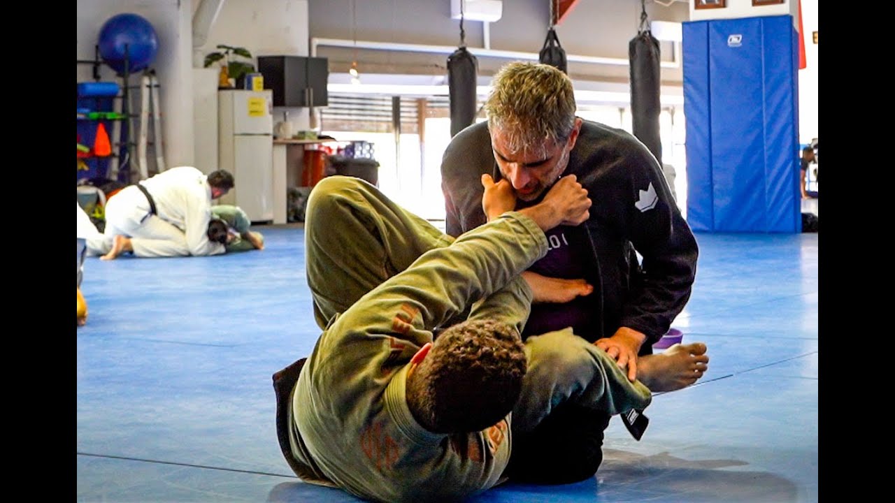 Rolling with a young purple belt