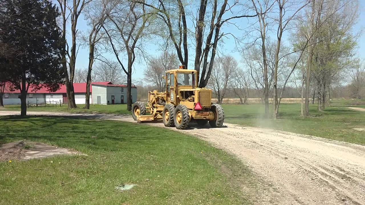 1964 CAT 12E grader - Putting the final touches to the road.