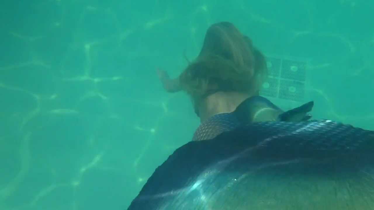 Trina Mason the mermaid swimming in the Wyndham Pool at Merpalooza