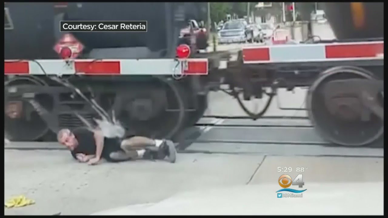 Man Rolls Under Moving Freight Train