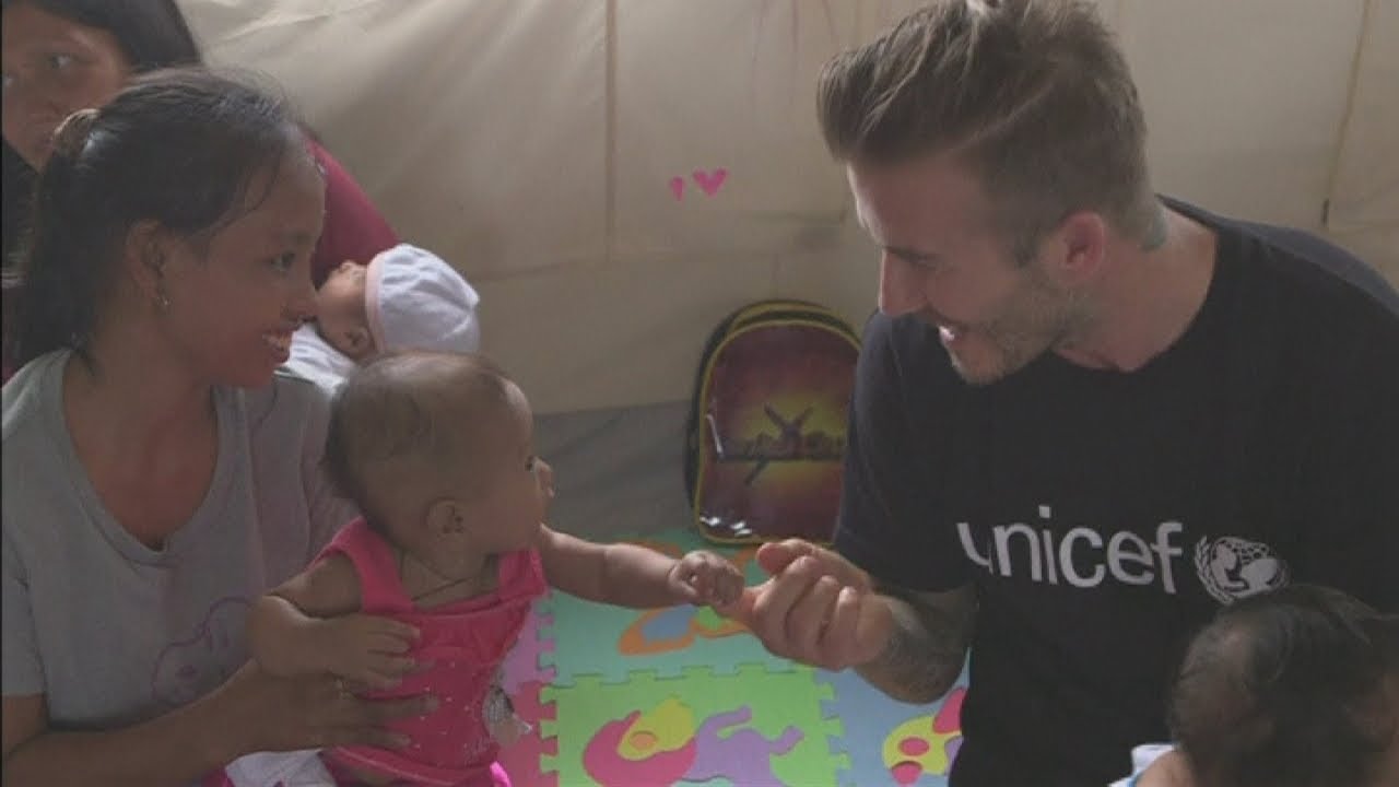 David Beckham plays with cute baby in the Philippines