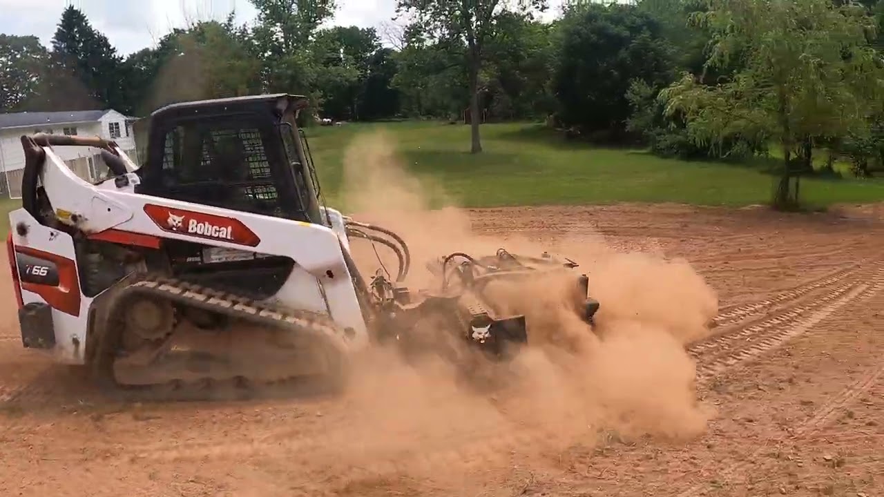 Tilling a yard with Bobcat T66 and Harley rake