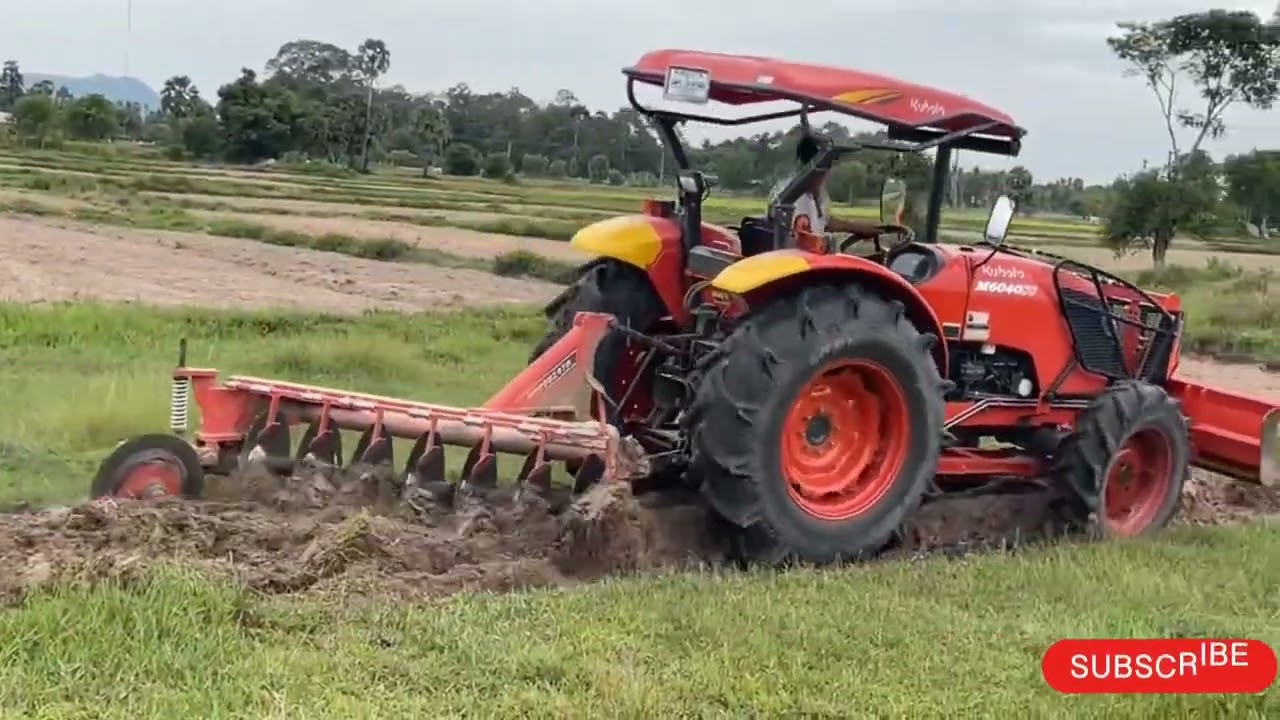 Tractor plowing rice fields in water