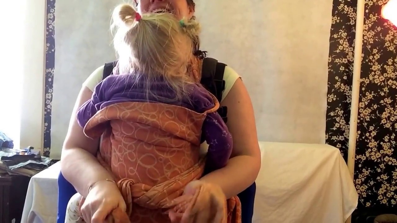 Adding meh dai mei tai front with baby kid on back in buckle carrier threading straps through back