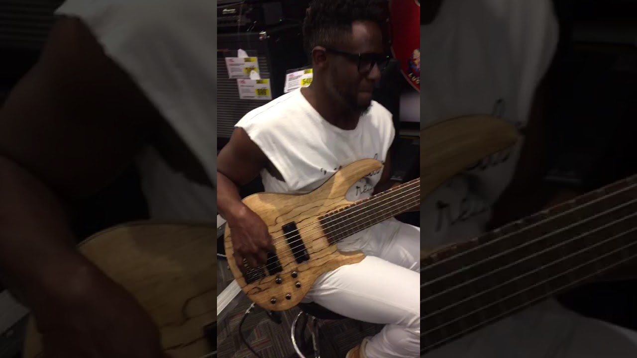 Mark Melius trying out the ESP LTD 6 string bass sample at the Music store.