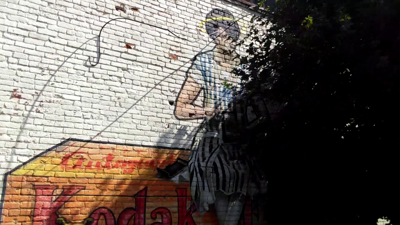 Mural of a Woman Sitting on a Box of Kodak Film, Near Paul Wolk Commons on Lake Avenue in Rochester,