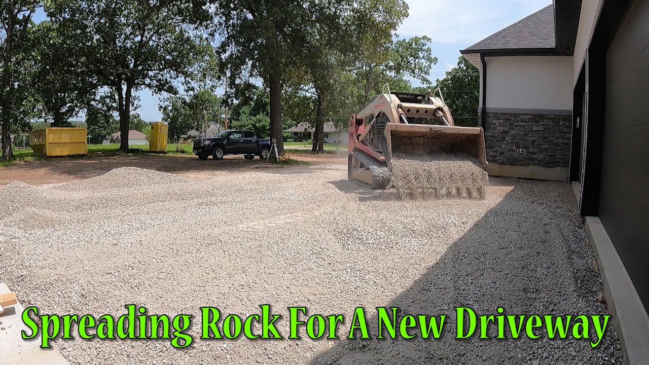 Spreading Rock On This New Construction Driveway For The Concrete Guys