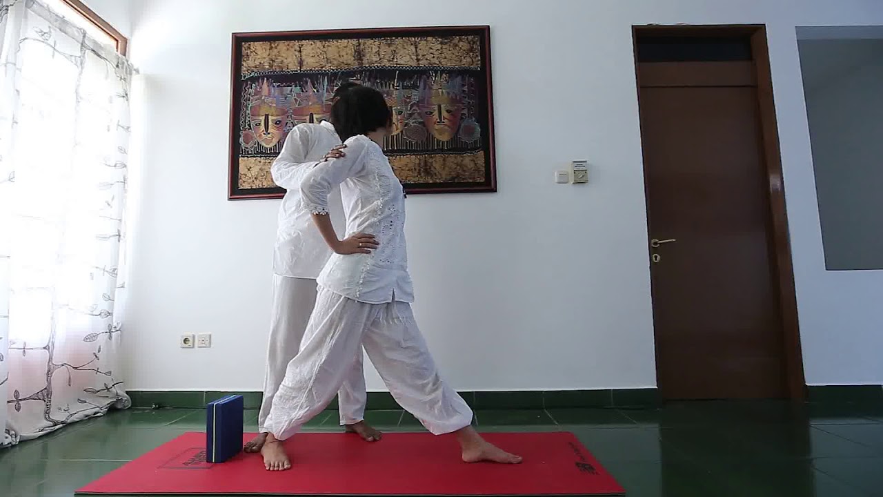 Twisted triangle pose adjustment and alignment by Yogi Arijit