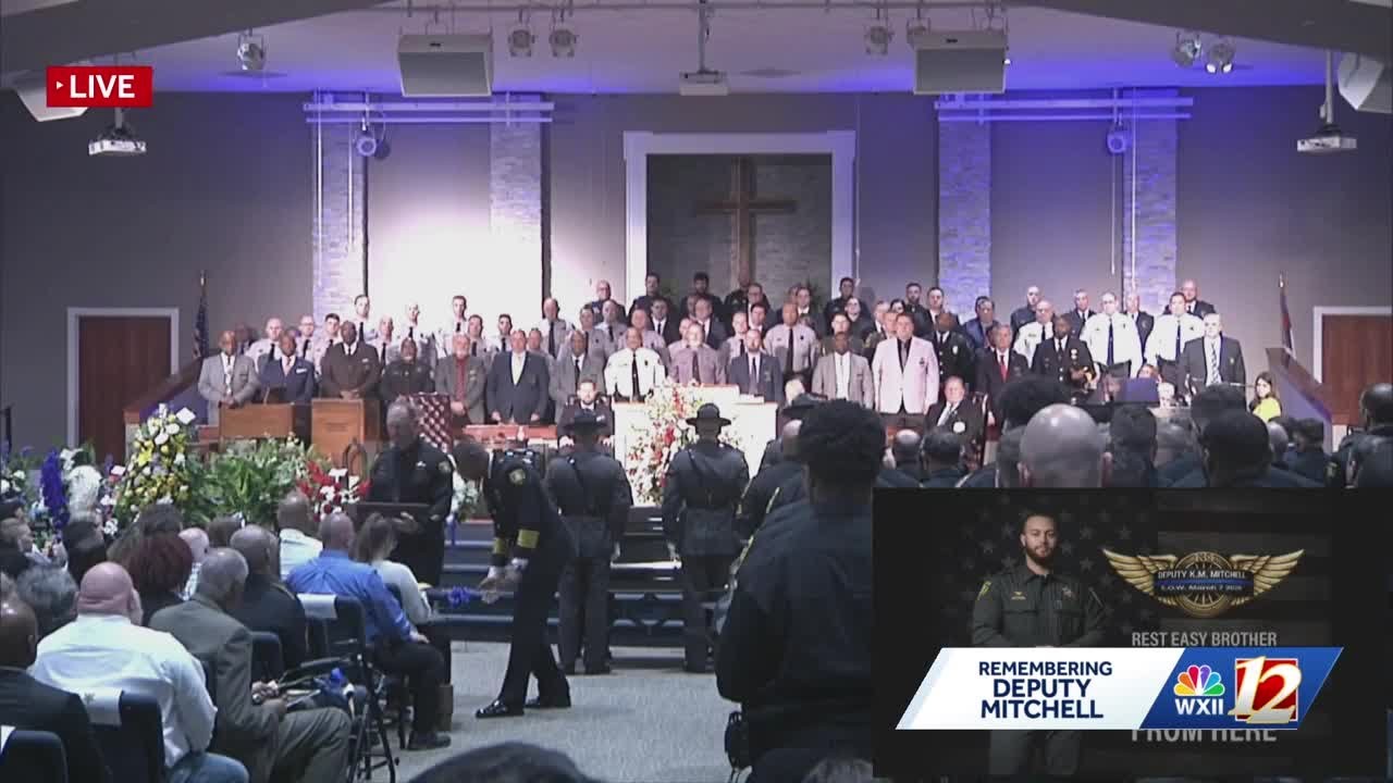 Sheriff Bobby Kimbrough presents Deputy Mitchell's widow with the American Flag