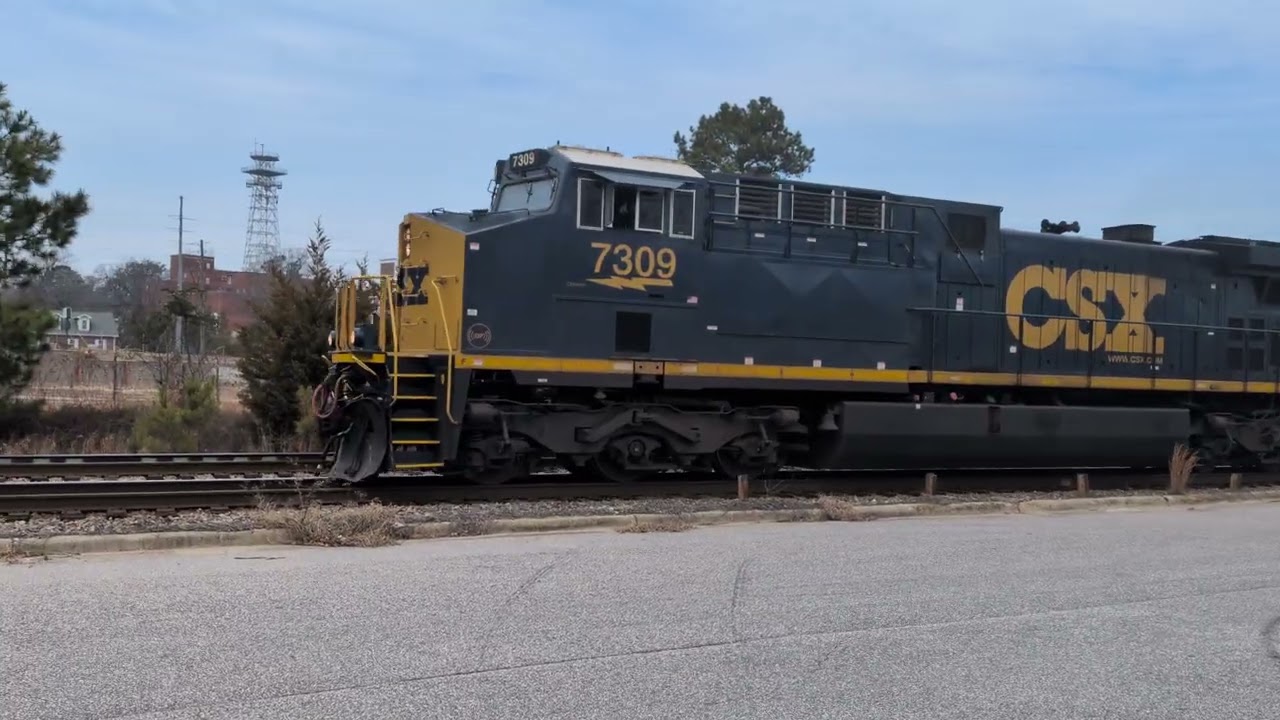 CSX 7309 leads a slow moving mixed freight down Winslow Street in Fayetteville, N.C. 2/25/2026