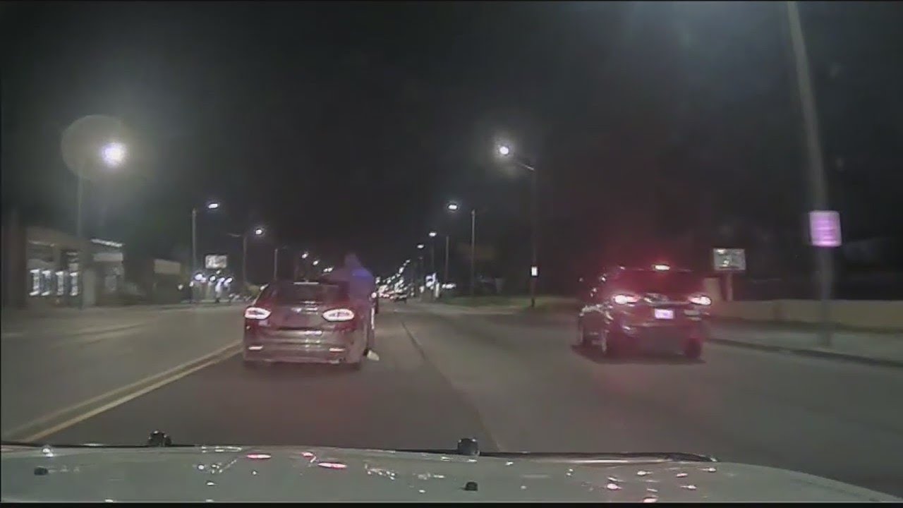 Gunman who hung out of car shooting at Detroit police, arrested tonight