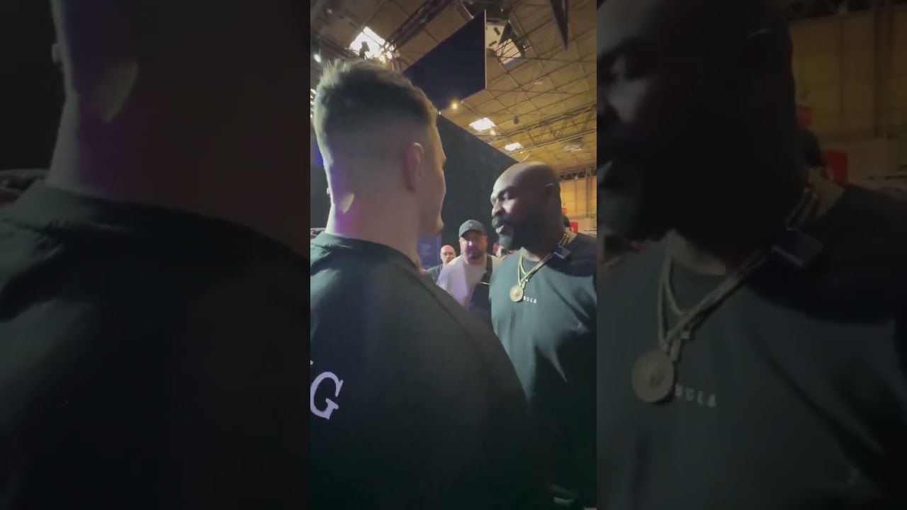 UFC Heavyweight Champion Jon Jones shrugs off Tom Aspinall's hand from his shoulder