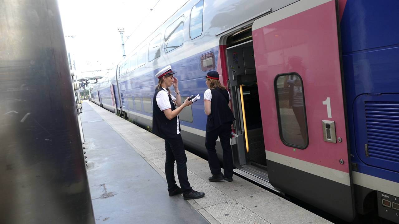 The platform guard blows her whistle for TGV Duplex 702 29 705