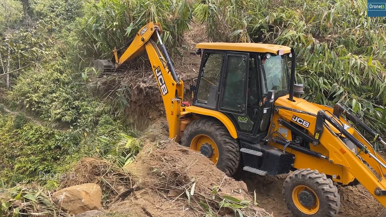 Mountain Top Narrow Road Building Cutting Steep Hillside with JCB Backhoe