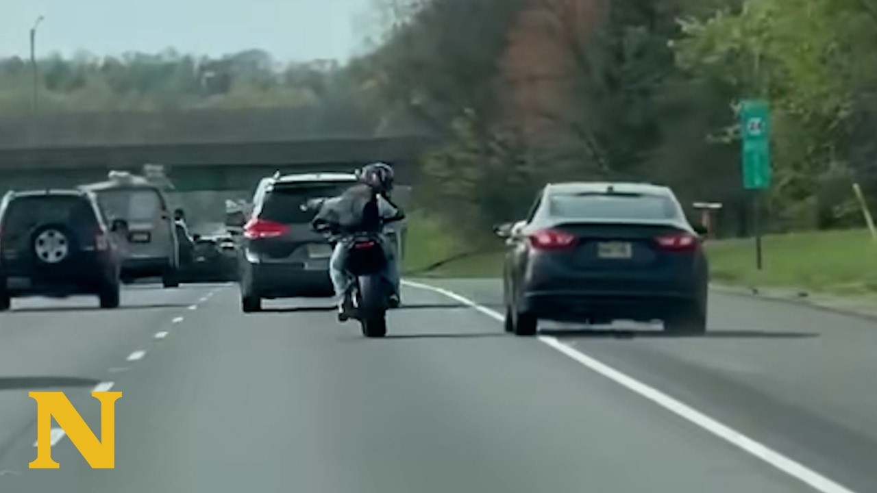 A driver and motorcyclist start arguing in traffic