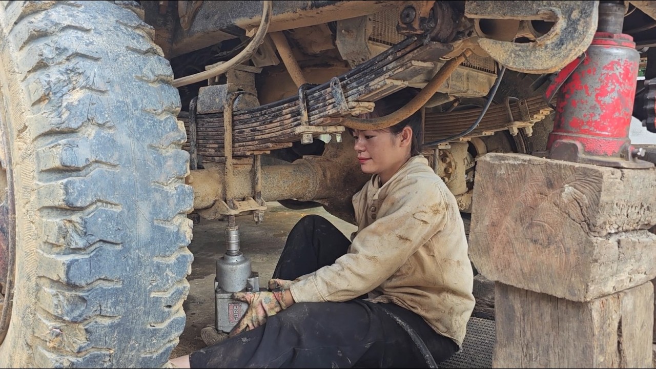 Female auto mechanic: replacing a truck leaf spring snapped in two