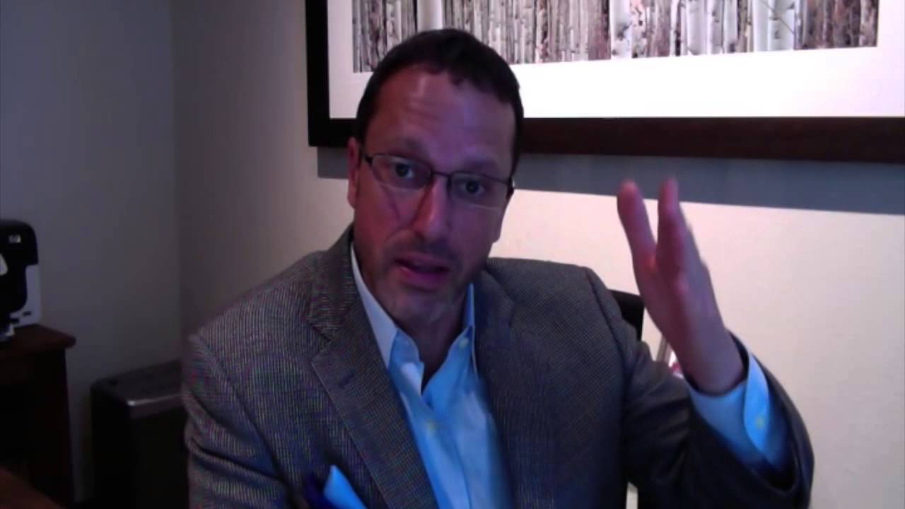 When does Dr. Lowenstein use a breast implant with a breast lift?