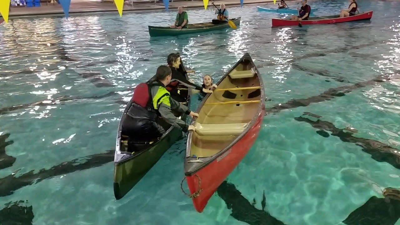 Getting into a canoe from deep water