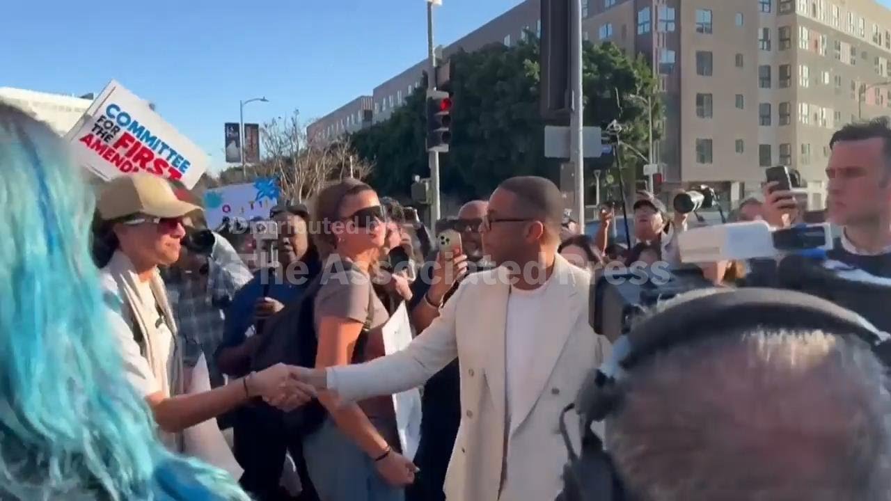 Journalist Don Lemon shakes hands with supporters after being released from custody