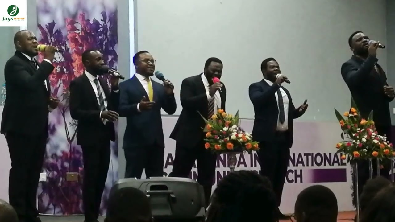 Am saved like the criminal by Omega Gents featuring Emmanuel Mulube