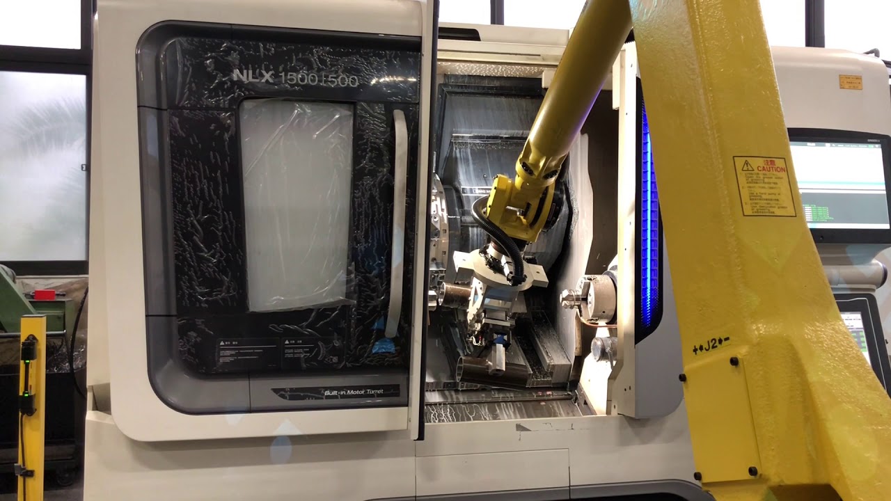 DMG MORI NLX1500 loaded by FANUC Robot with 7th Axis.