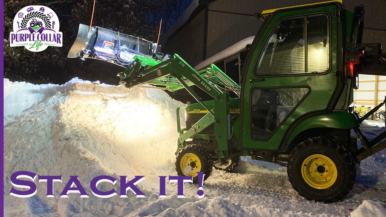 Stack it high. Tractor loader snow plow
