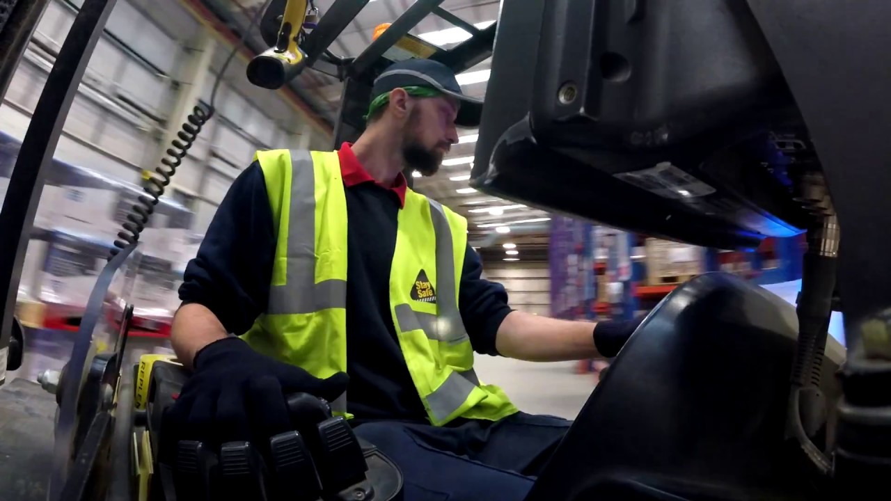 Driving reach truck at UK warehouse.