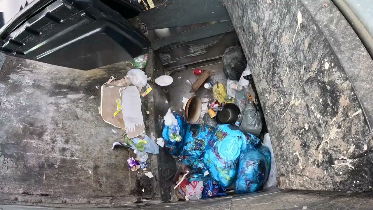 Garbage truck hopper POV: McNeilus ZR packing some mid-week trash