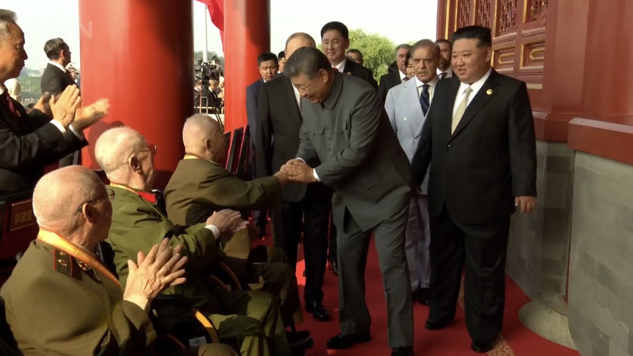 President Xi Jinping greets veterans on Tian'anmen Rostrum