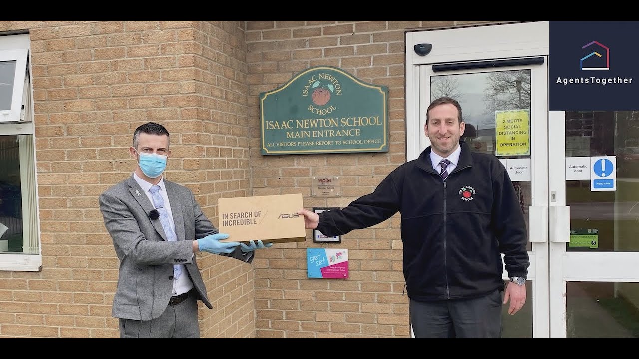 Chris Heathcote, head of Sir Isaac Newton School in Grantham, receives a laptop from Agents Together