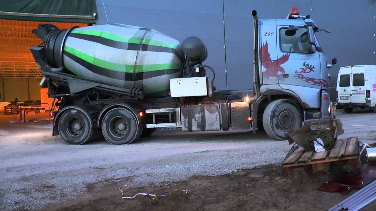 Scania and Volvo trucks delivering concrete for flooring in large construction 2013