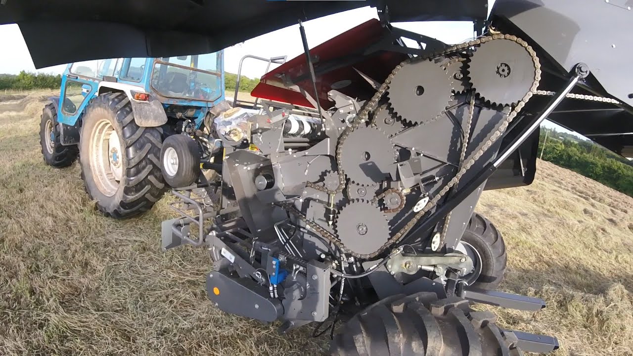 Using a brand new round baler on the 7810 - raking and baling hay