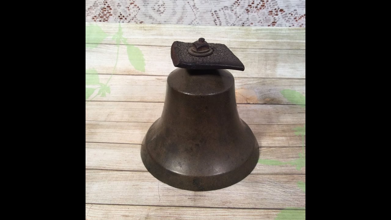 The ringing of an old cow bell.