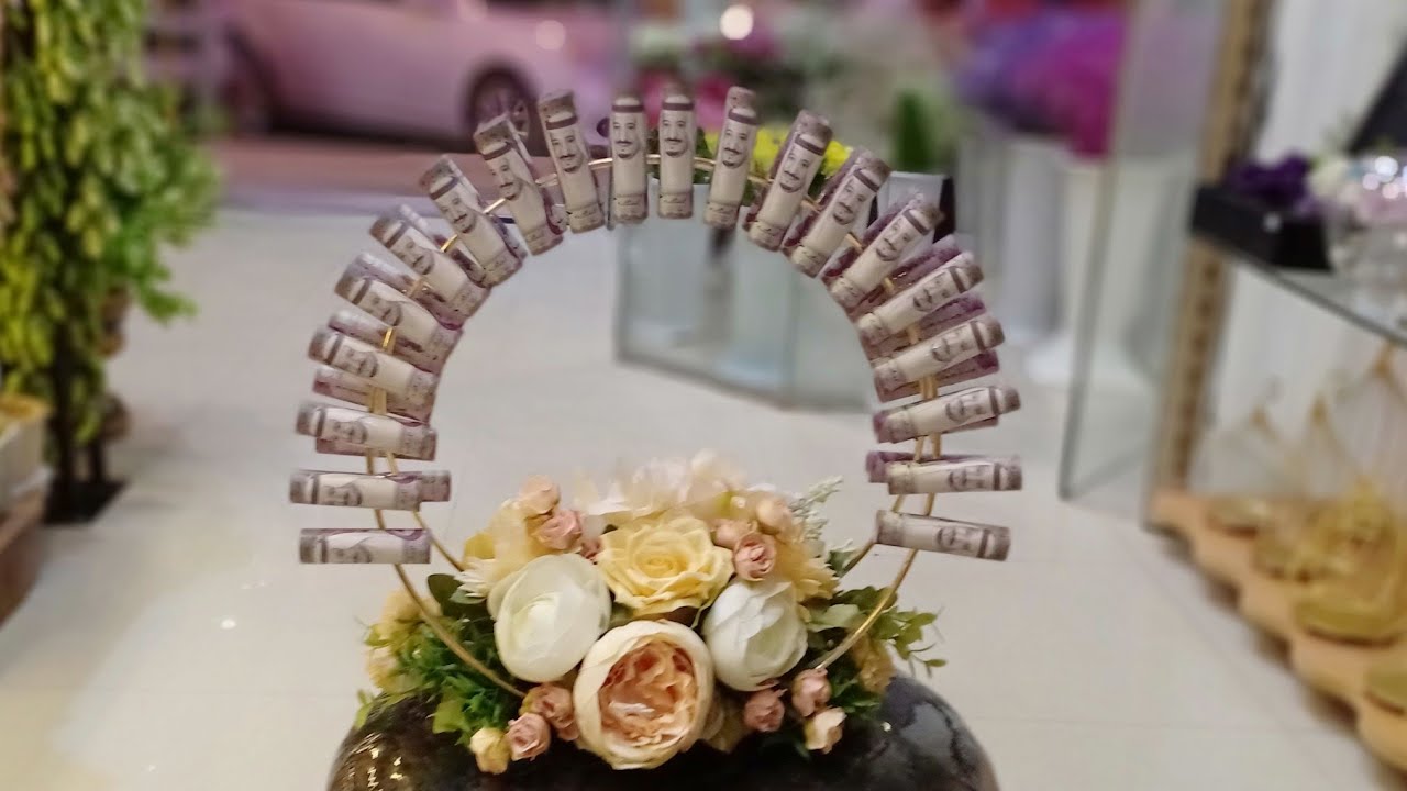 Flower and money arrangement