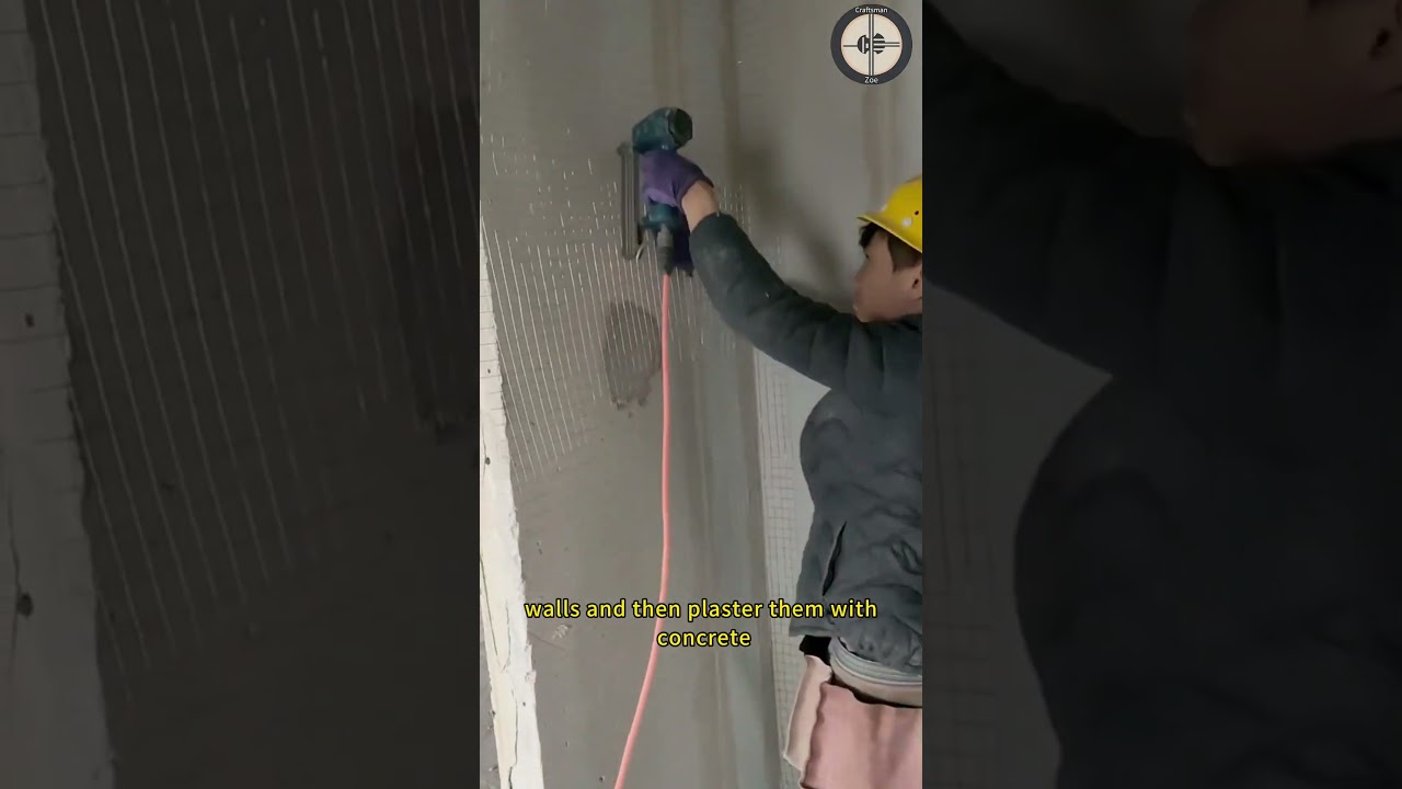 Workers install steel wire mesh on indoor walls and then plaster them with concrete