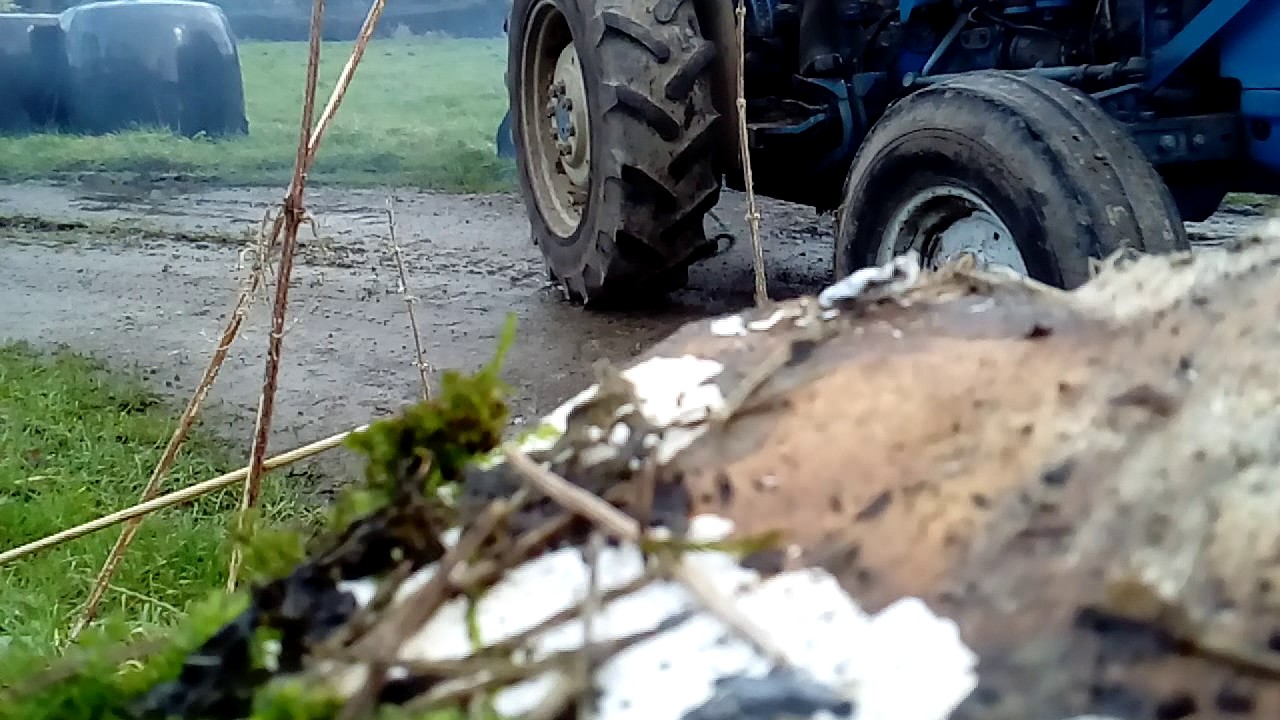 Ford 3910 lifting a bale