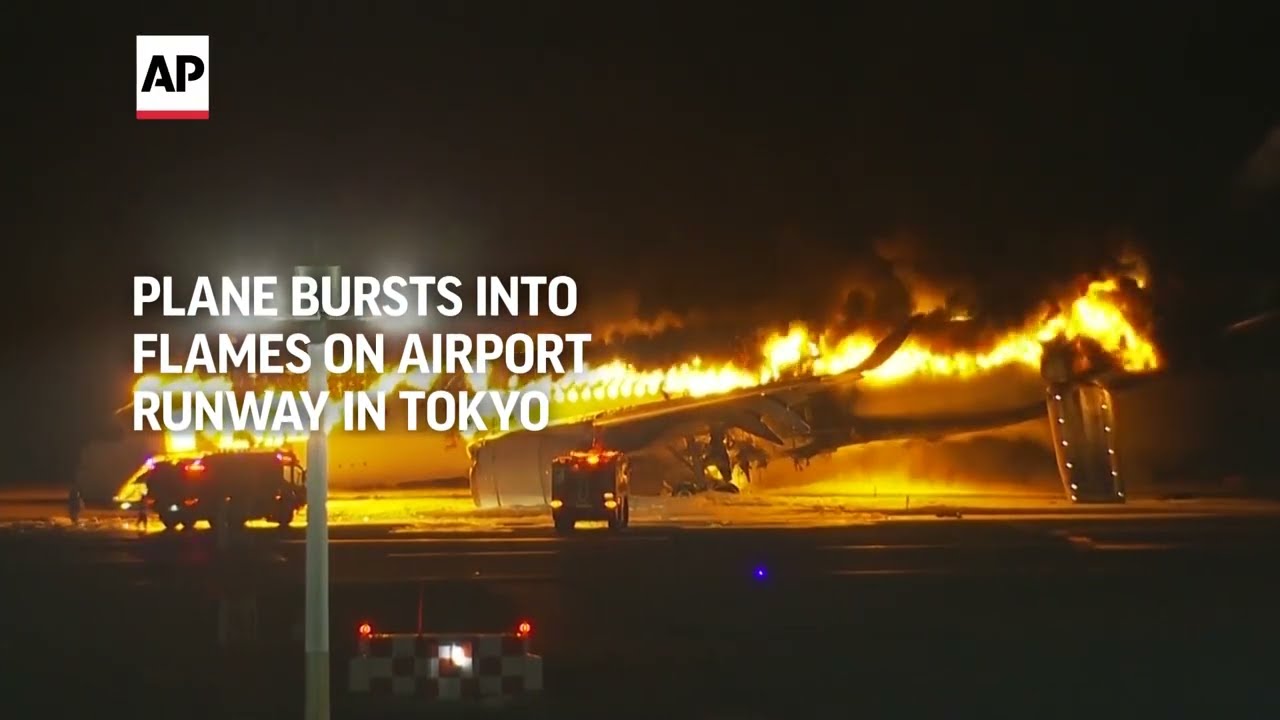 Plane bursts into flames on airport runway in Tokyo