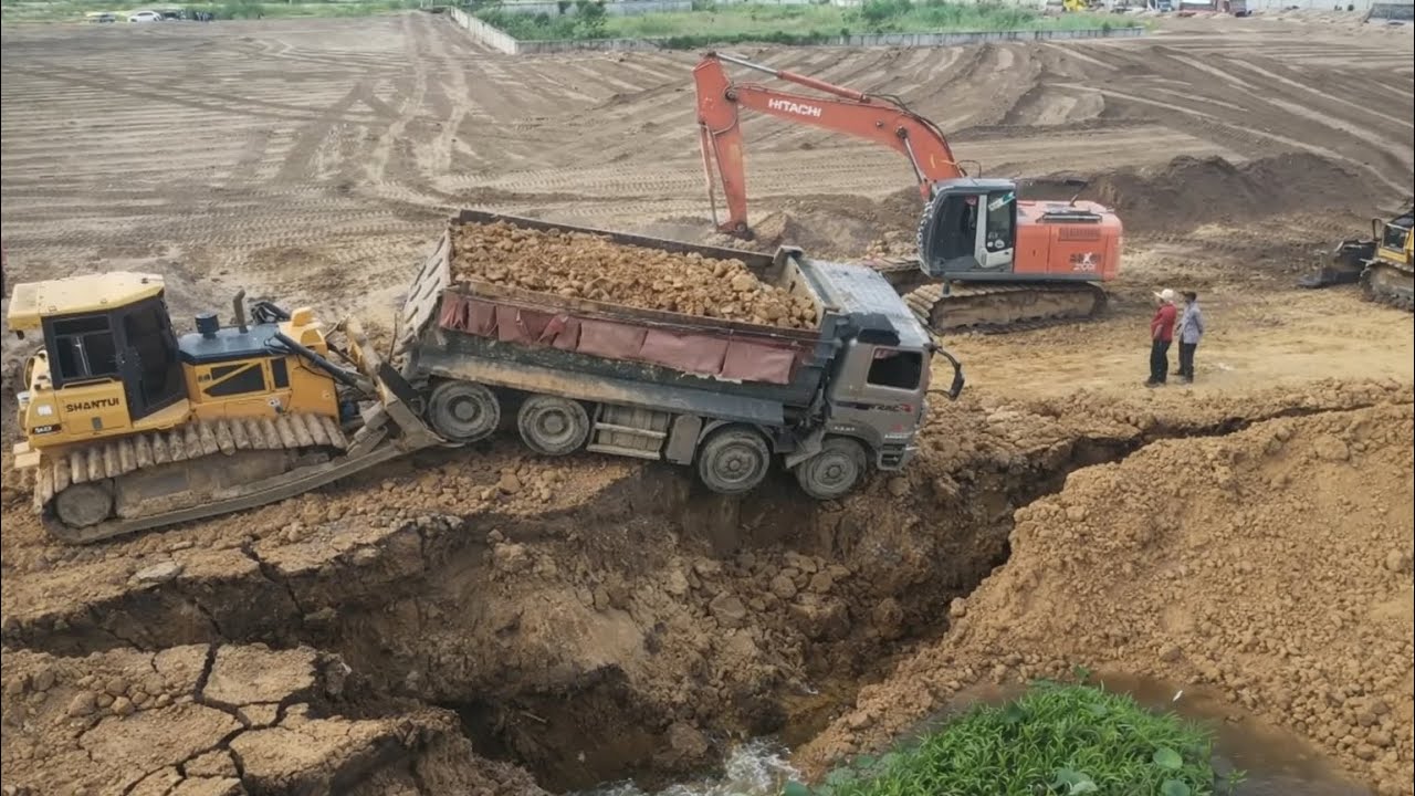 Shantui Dozer Helping Dump Trucks Of Falling With Excavator On The Big Land