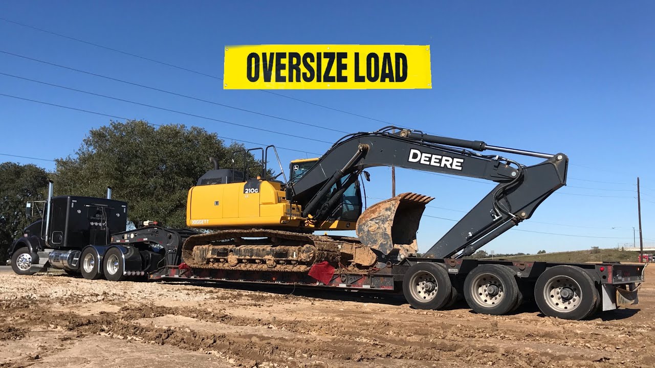 kenworth hauling heavy excavator | lowboy side loading and unloading