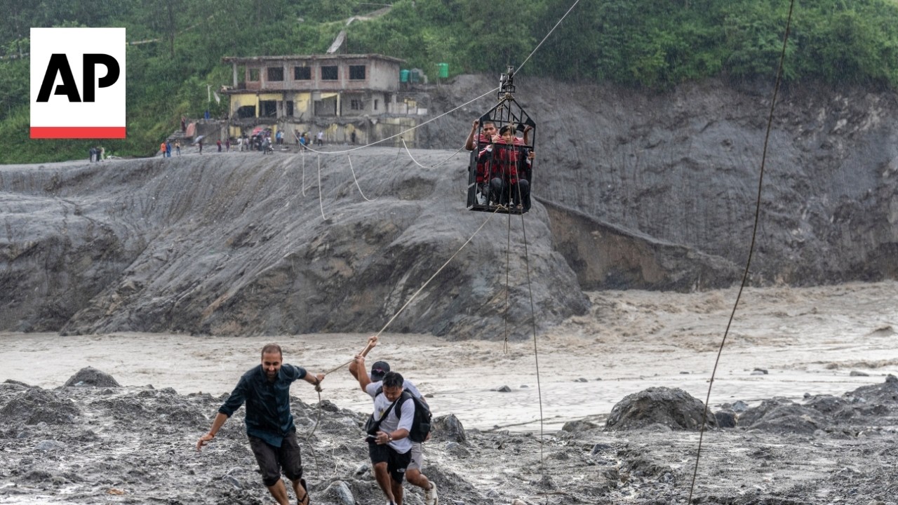 Nepal army makes a zip line to help people cross a river after floods