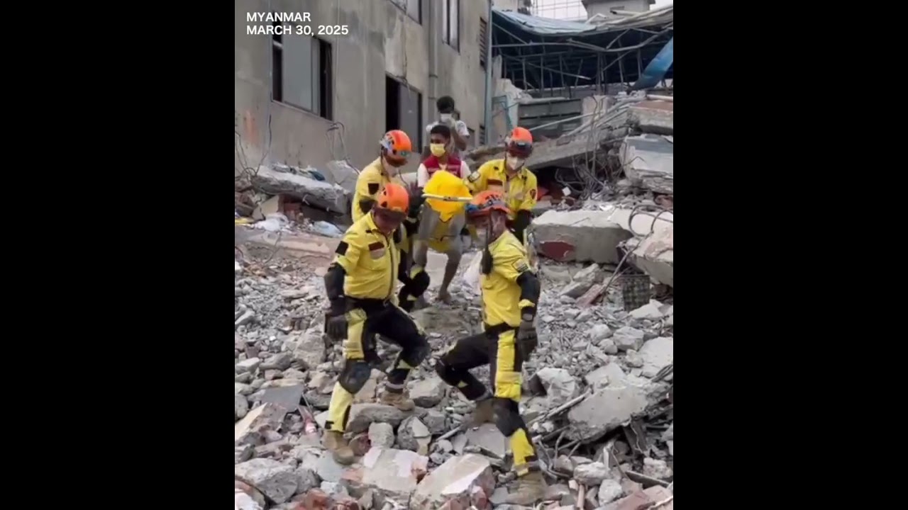 Chinese civilian rescue team pull out a survivor from rubbles in quake-hit Mandalay, Myanmar