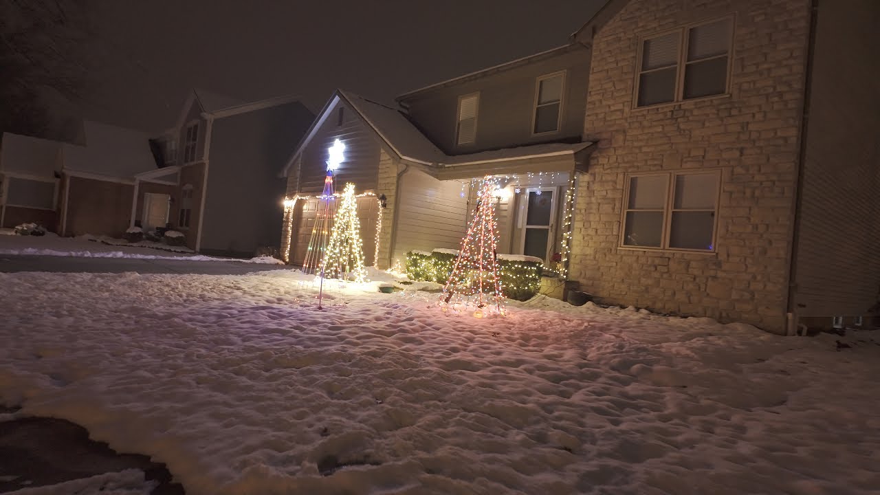 A peaceful nighttime walk surrounded by glowing Christmas lights.