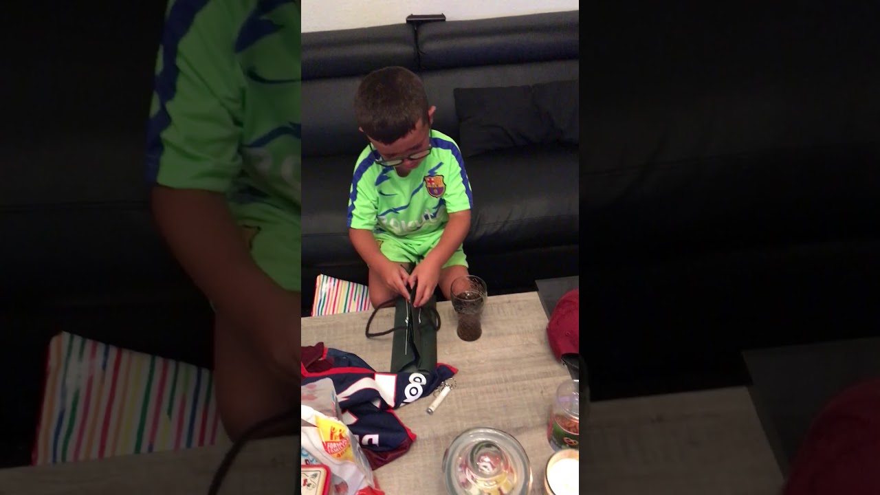 Gamin fan de l'OM a qui on offre un maillot de Paris